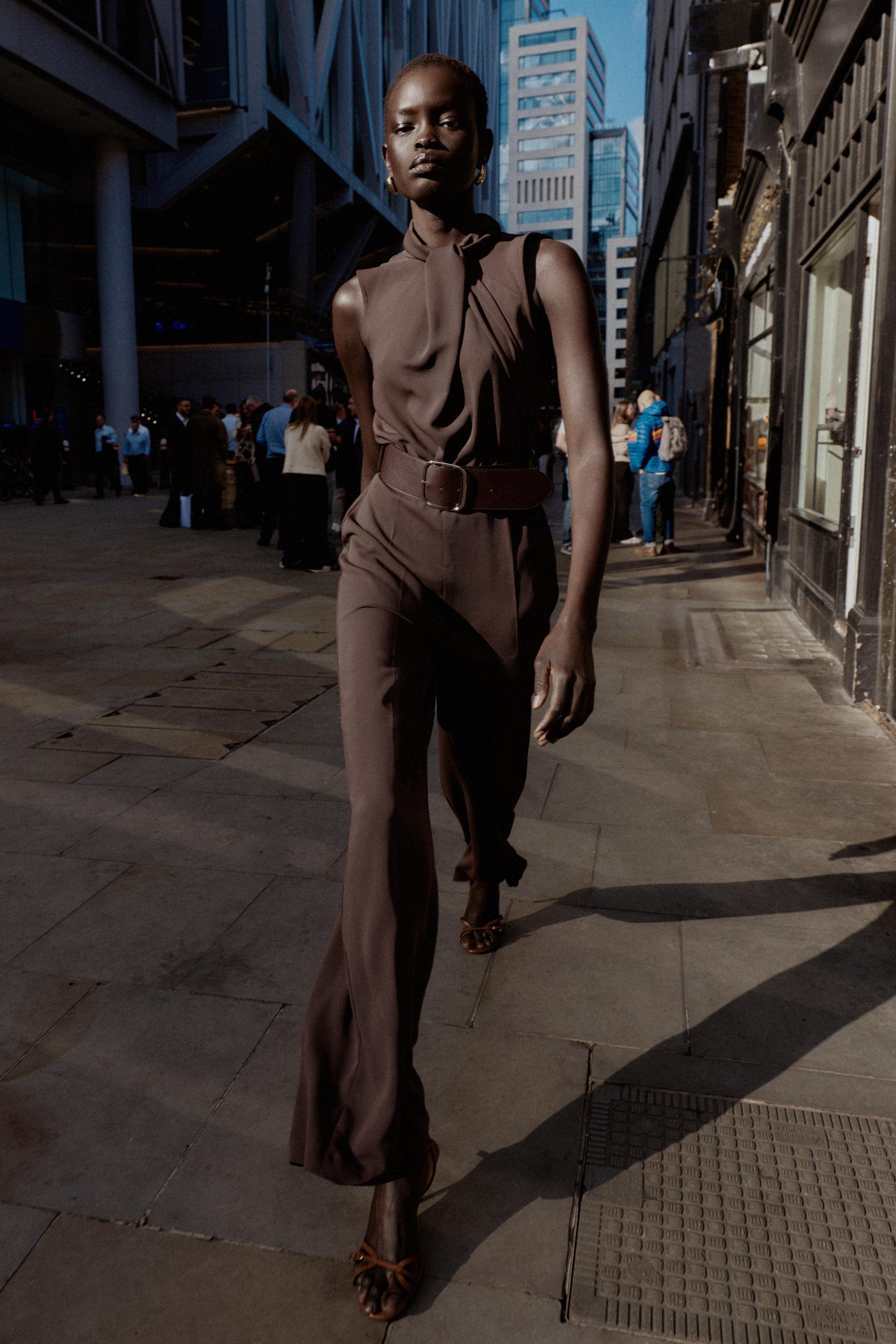 SLEEVELESS BELTED JUMPSUIT